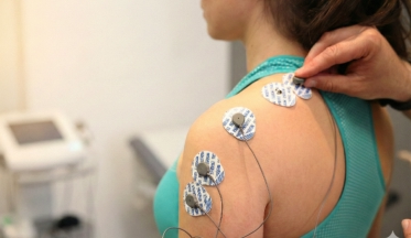 Fisioterapeuta en fisioterapia oceano Móstoles valorando con electromiografía muscular a un paciente